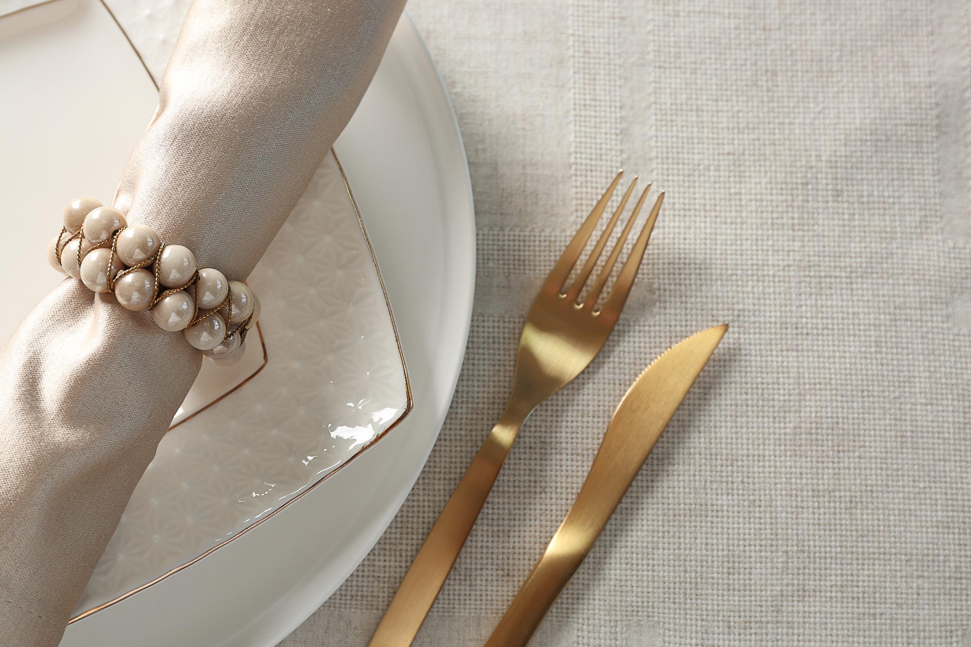 Set table with linen and gold cutlery